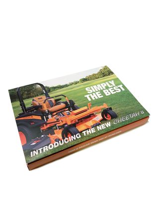 A closed box with the words 'Simply the best' and 'Introducing the new Cheetah II' printed over a photo of a Scag lawn mower.